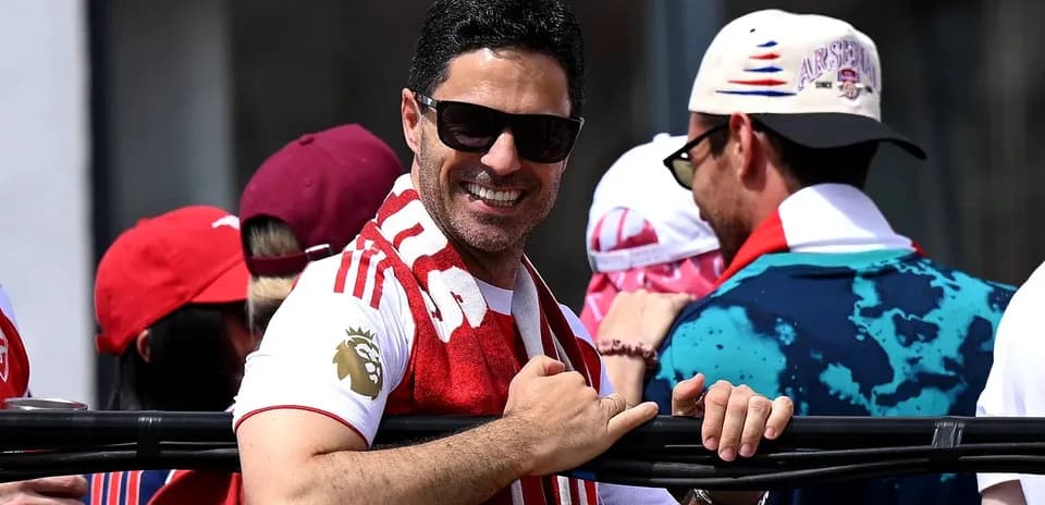 Fan smiling with Arsenal scarf at event