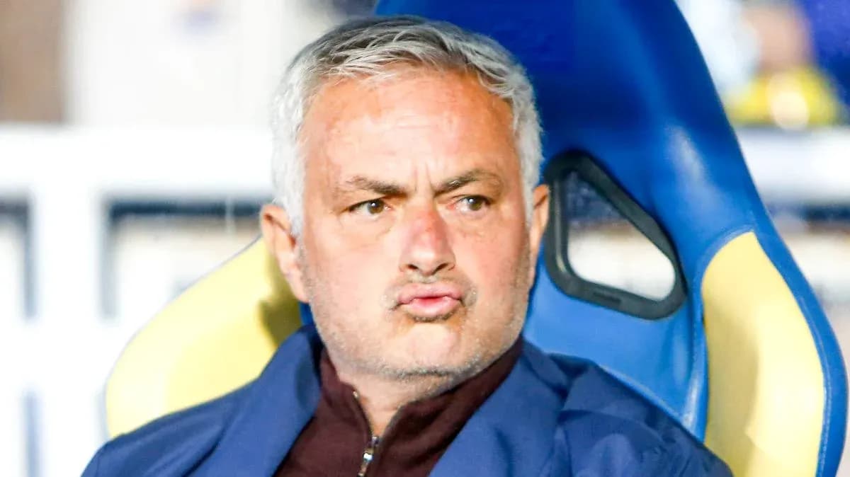 Football manager seated on the bench during a match Football manager seated on the bench during a match
