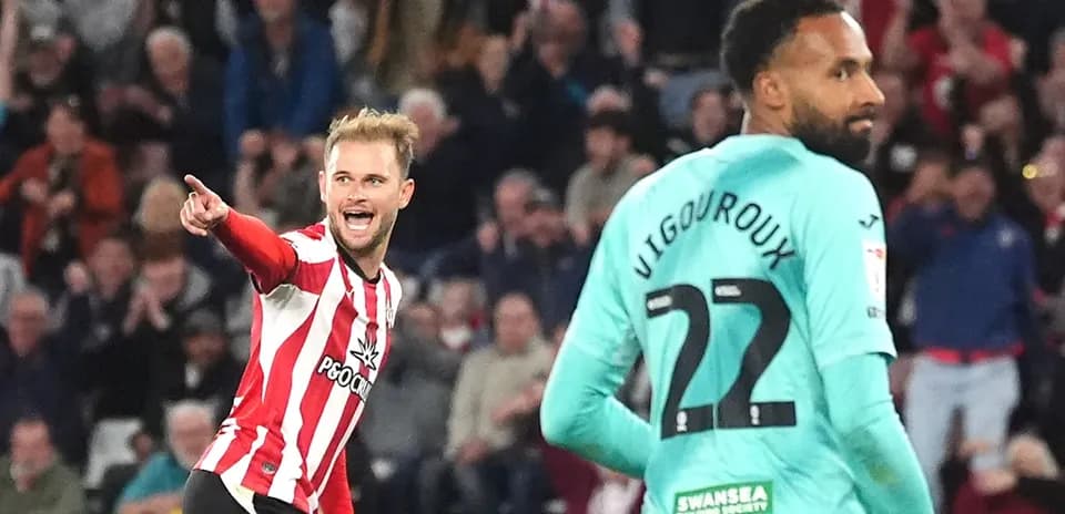 Player celebrating a goal against goalkeeper during match