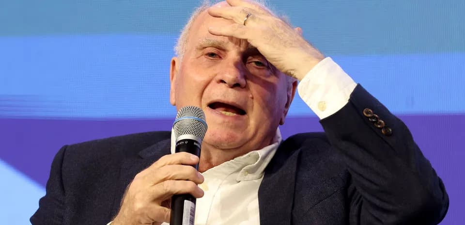 Man speaking into a microphone during event