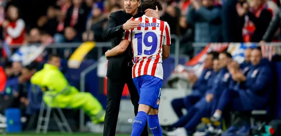 Coach embracing player during match celebration