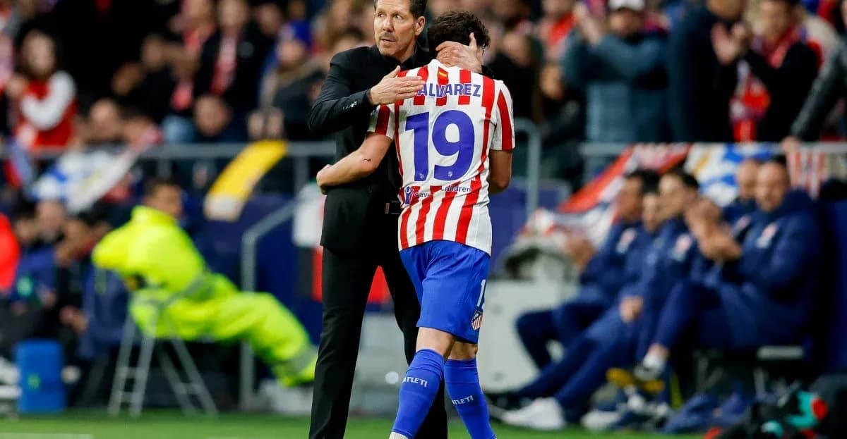 Coach embracing player during match celebration