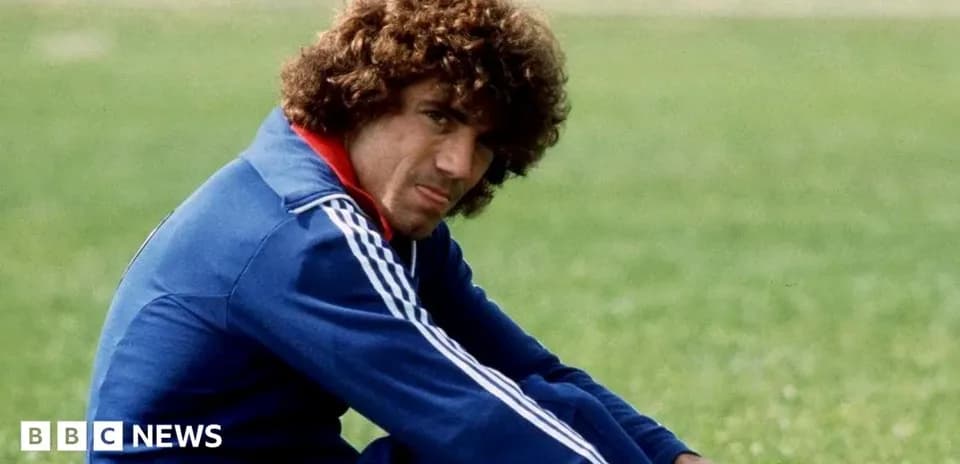 Player sitting on grass field in training gear