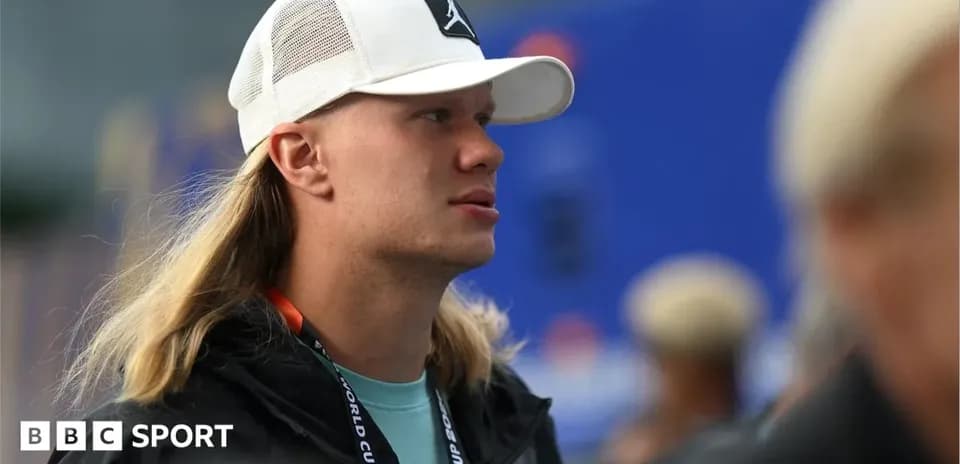 Person with long hair wearing a white cap