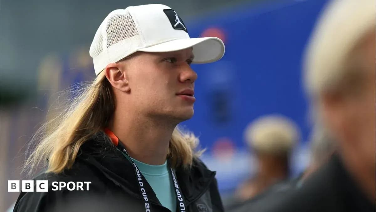 Person with long hair wearing a white cap
