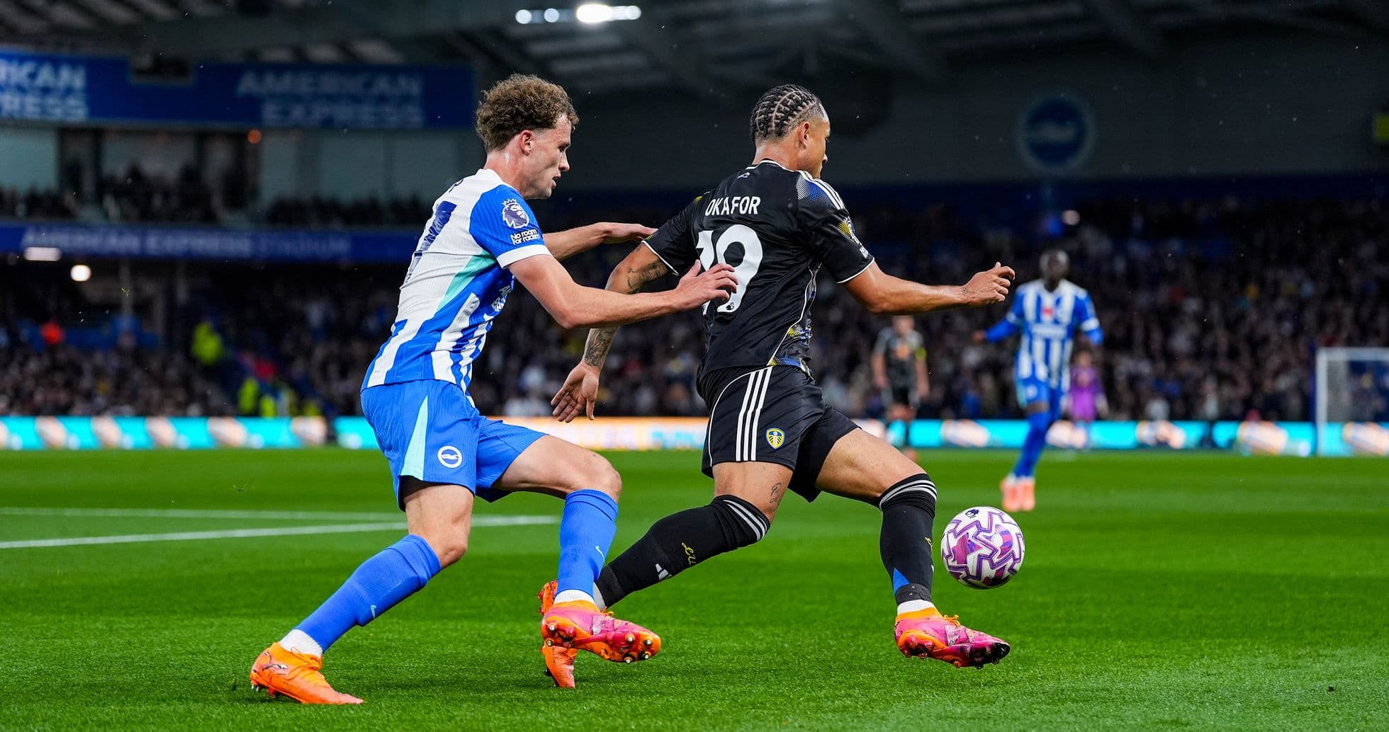 Leeds player dribbling past Brighton defender