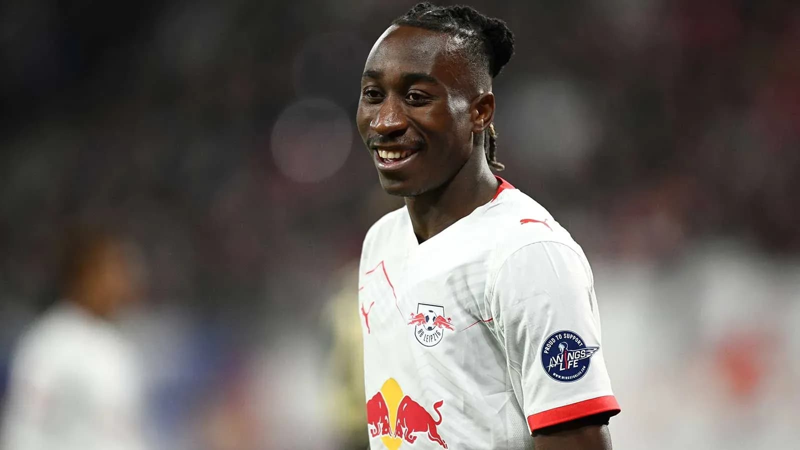 Player smiling in RB Leipzig match uniform