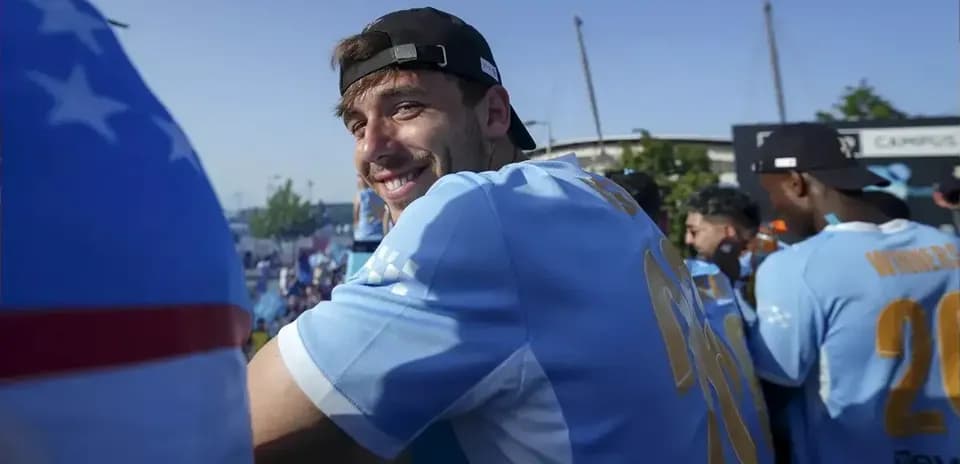 Player smiling during celebration event with teammates
