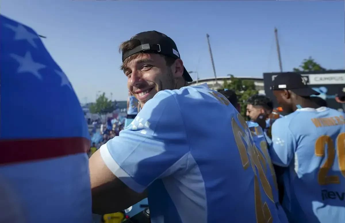 Player smiling during celebration event with teammates