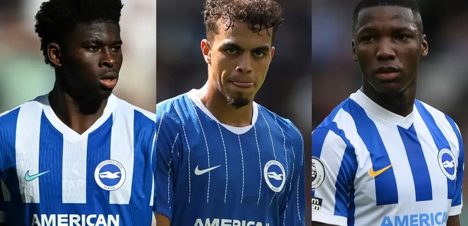 Three Brighton players in home jerseys on field