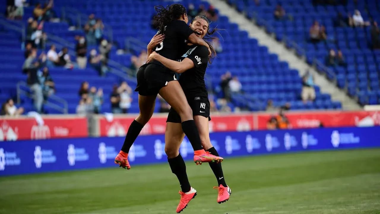 Players celebrating a goal during NWSL match