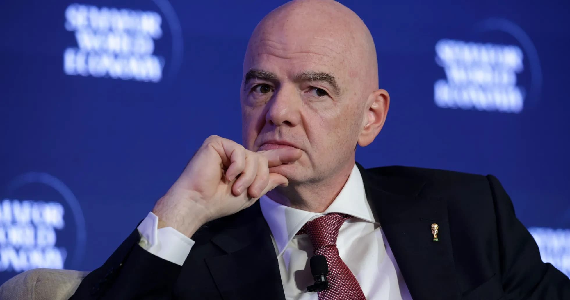 Official speaking at a conference with FIFA emblem