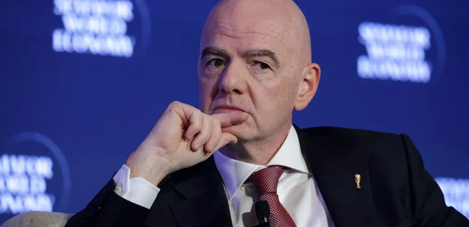 Official speaking at a conference with FIFA emblem