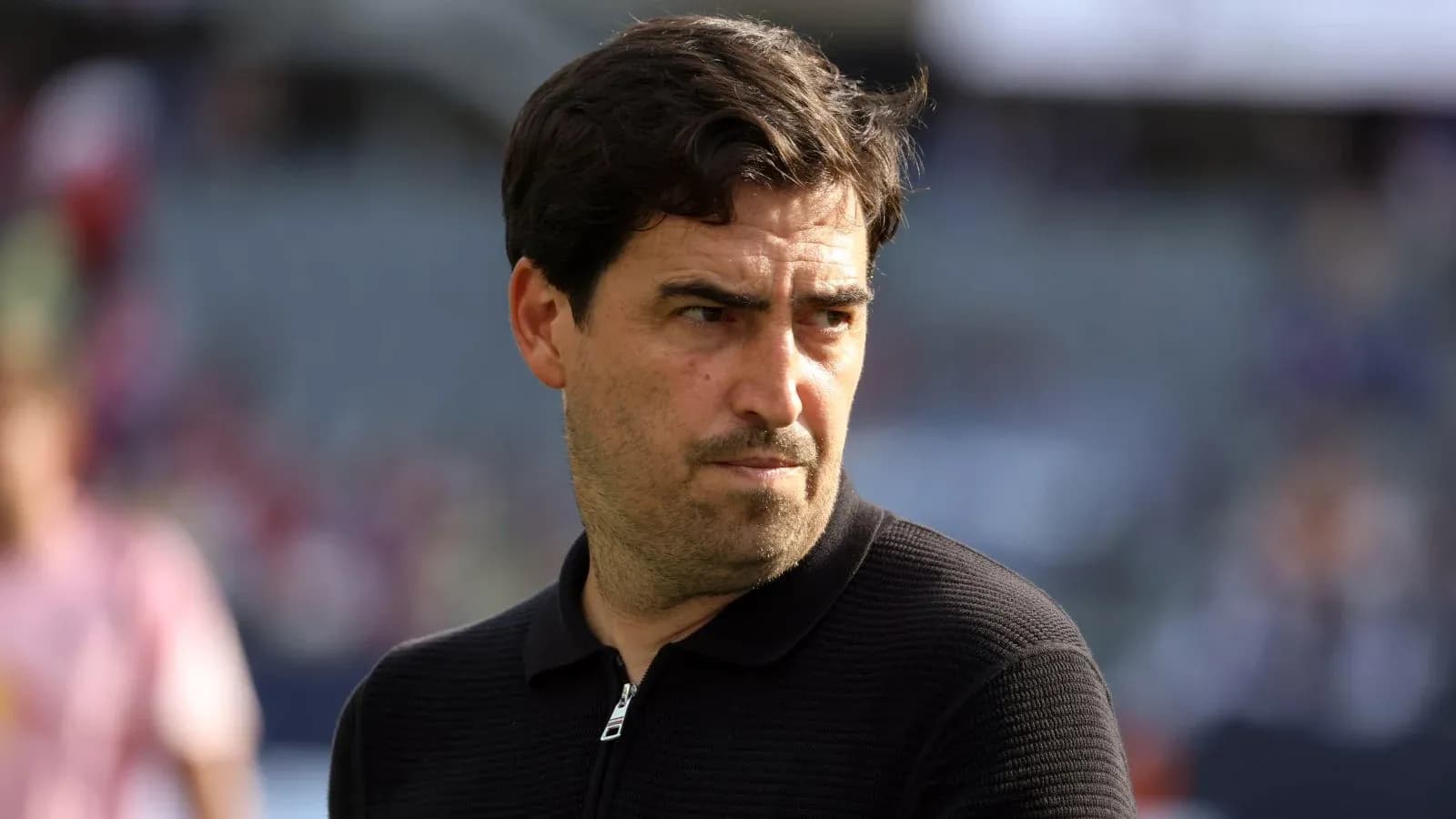 Coach observing match from the sidelines