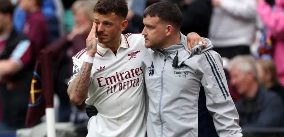 Player being assisted off the field after match