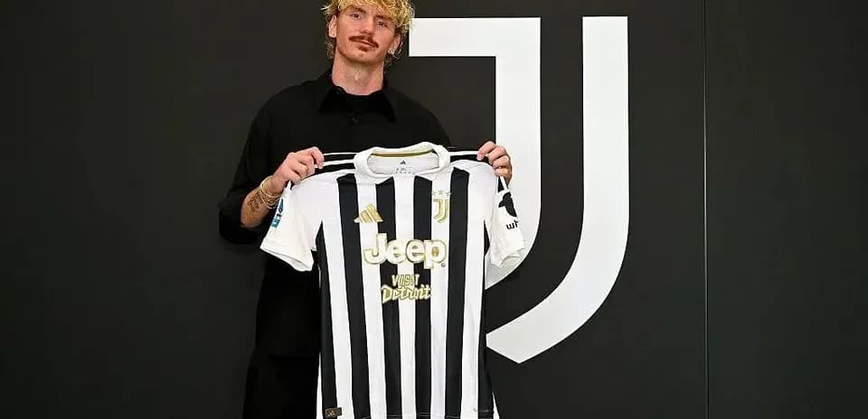 Player holding Juventus jersey at signing event