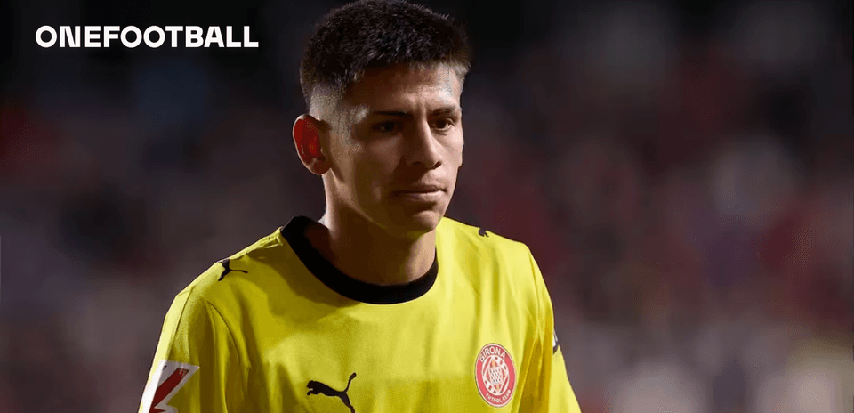 Goalkeeper wearing yellow jersey walking on the field