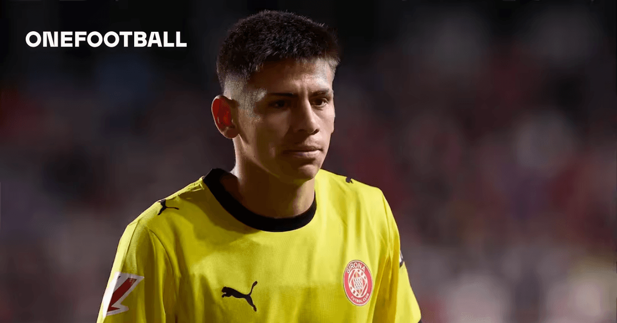 Goalkeeper wearing yellow jersey walking on the field