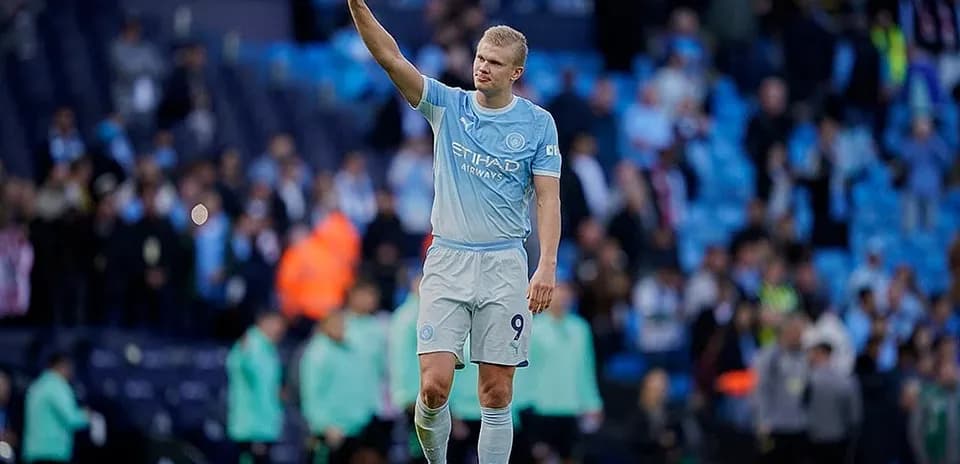 Manchester City player waving to fans
