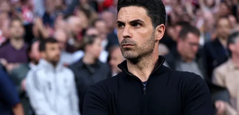 Coach observing match with focused expression in crowd