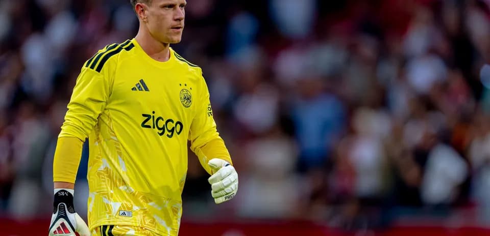Goalkeeper in yellow kit walking on the field