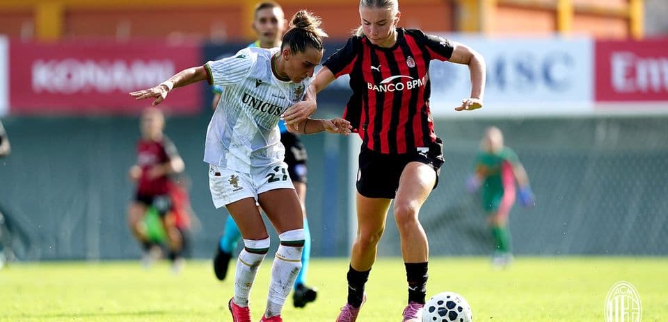 Two players competing for the ball in match