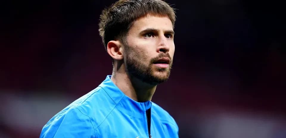 Player in blue training kit during warm-up
