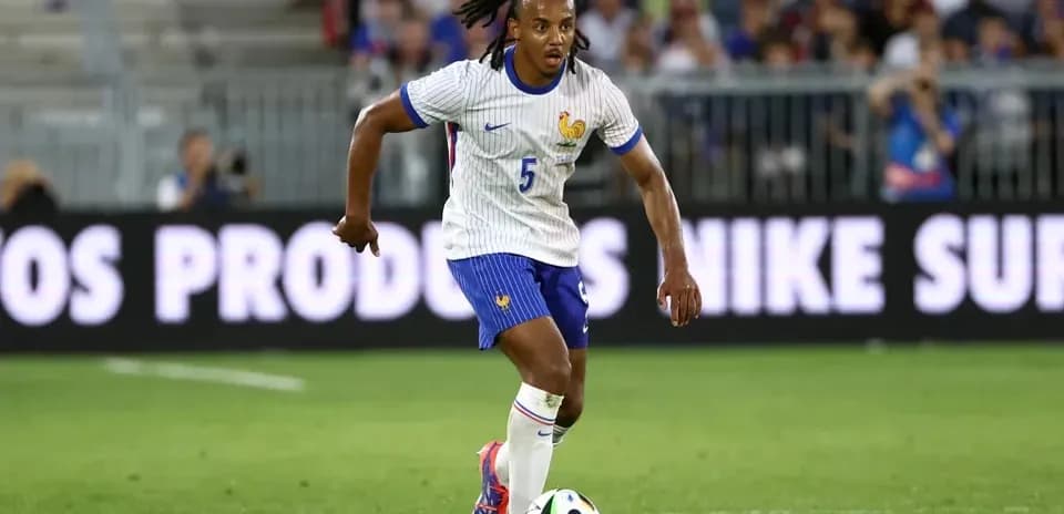 Player in France kit dribbling a soccer ball