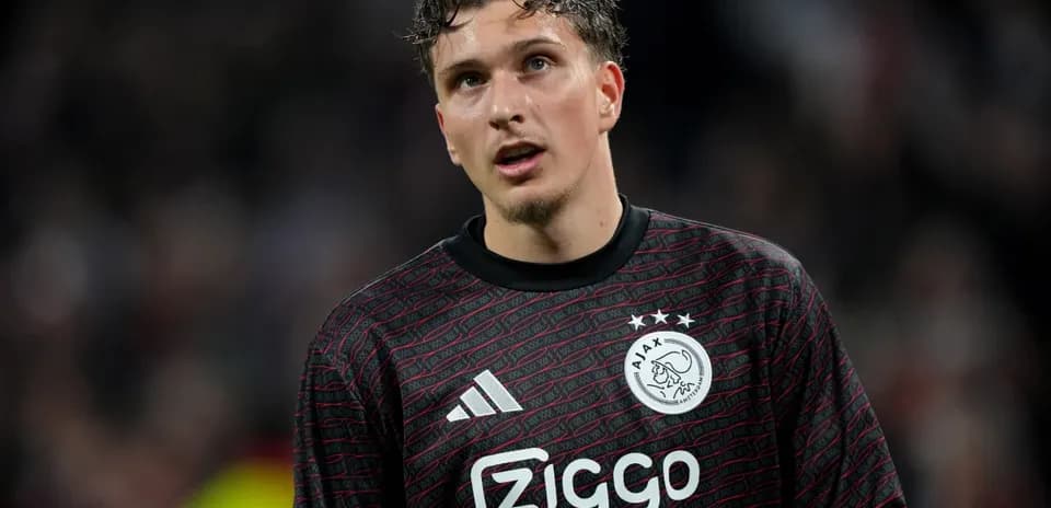 Goalkeeper in Ajax kit during match action