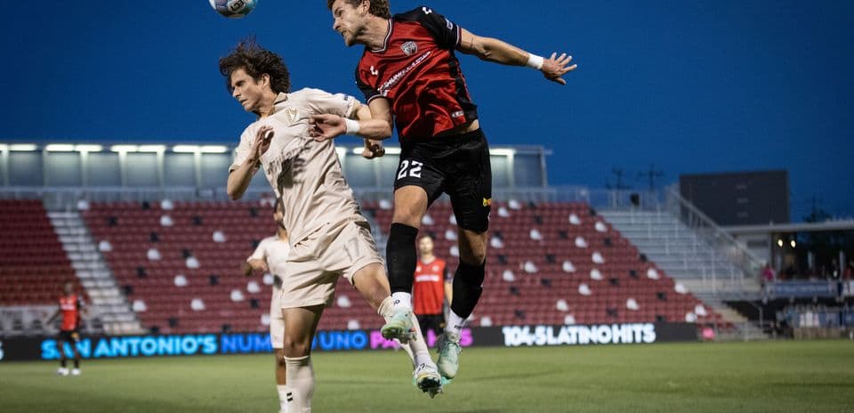 Players contesting for the ball during match