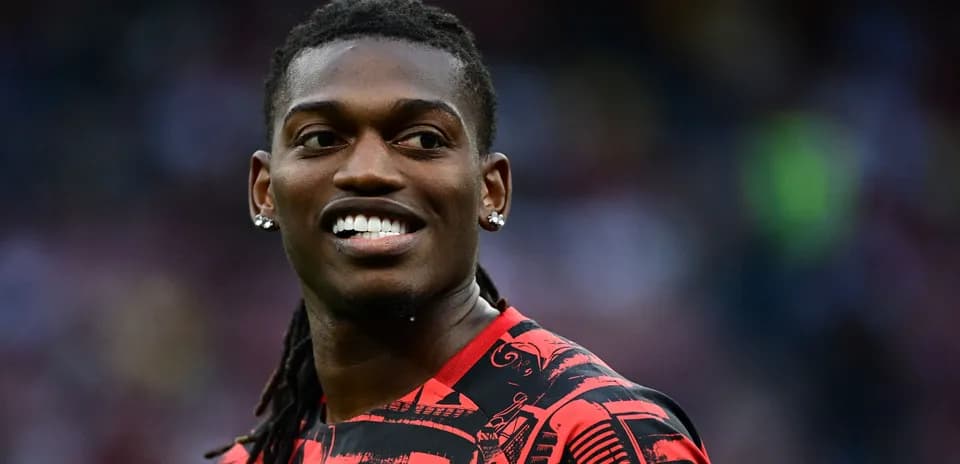 Player smiling in red and black sports jersey