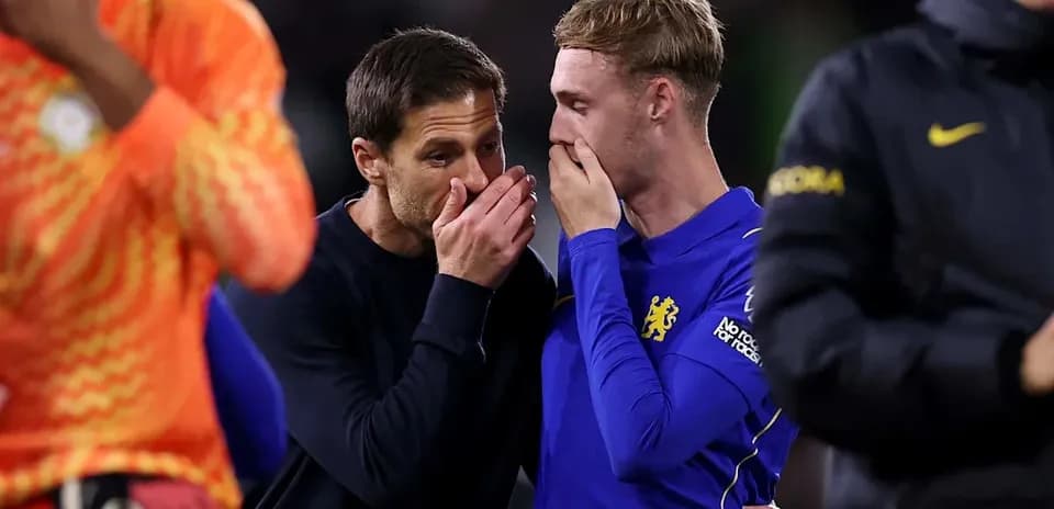 Coach and player discussing on the pitch after match