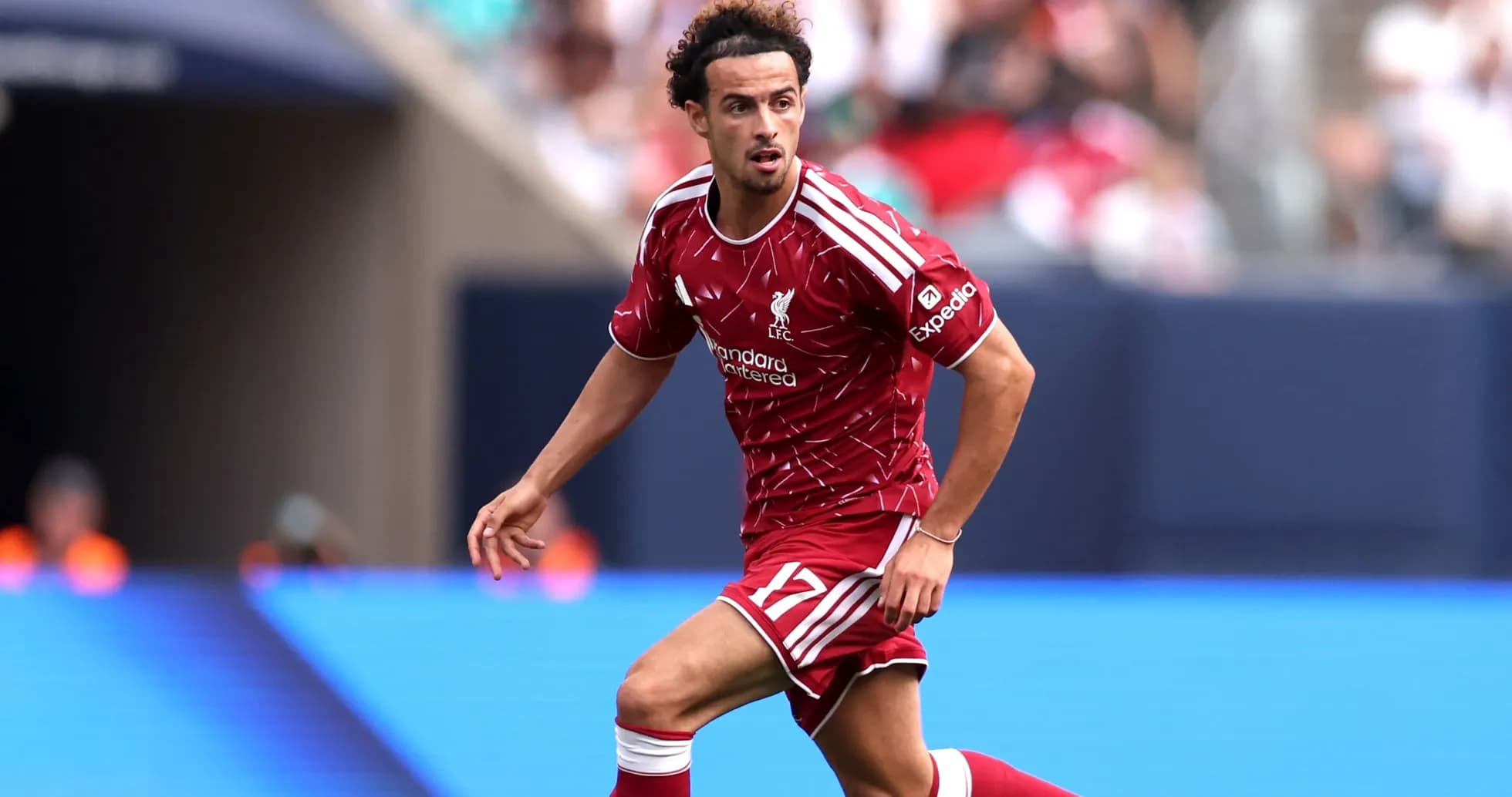 Player in Liverpool kit running during match