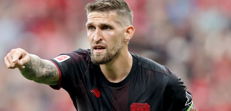Player gesturing during a match for Bayer Leverkusen