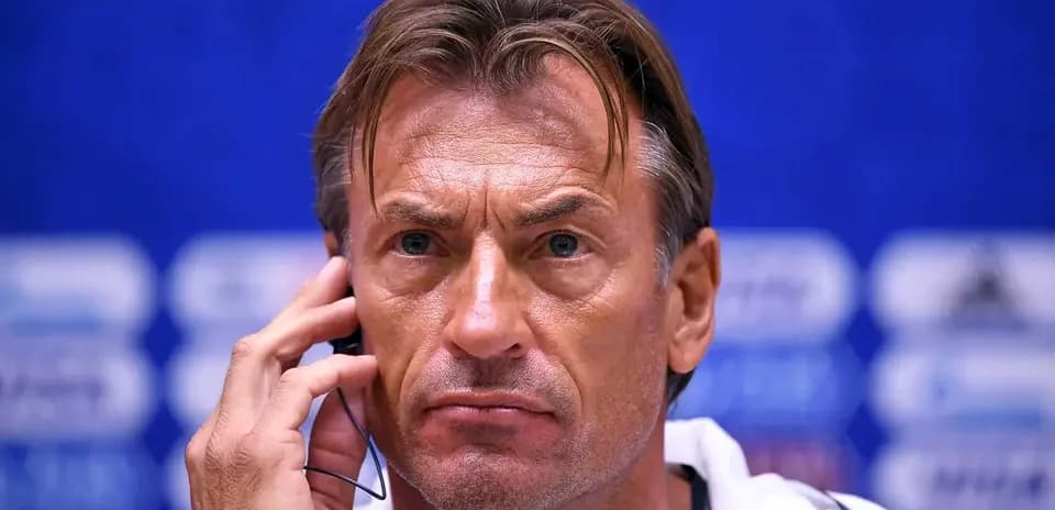 Coach listening during a press conference