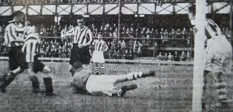 Players contesting a ball near the goalpost