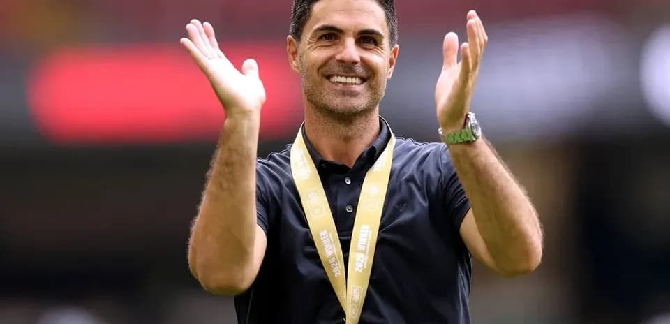 Coach celebrating with hands raised during event