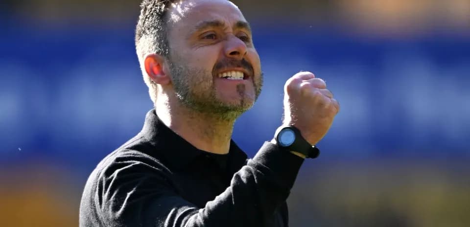 Coach celebrating with a clenched fist on sidelines