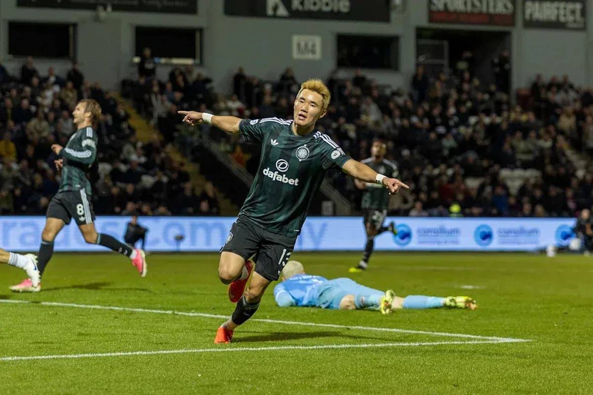 Player celebrating goal with teammates in background