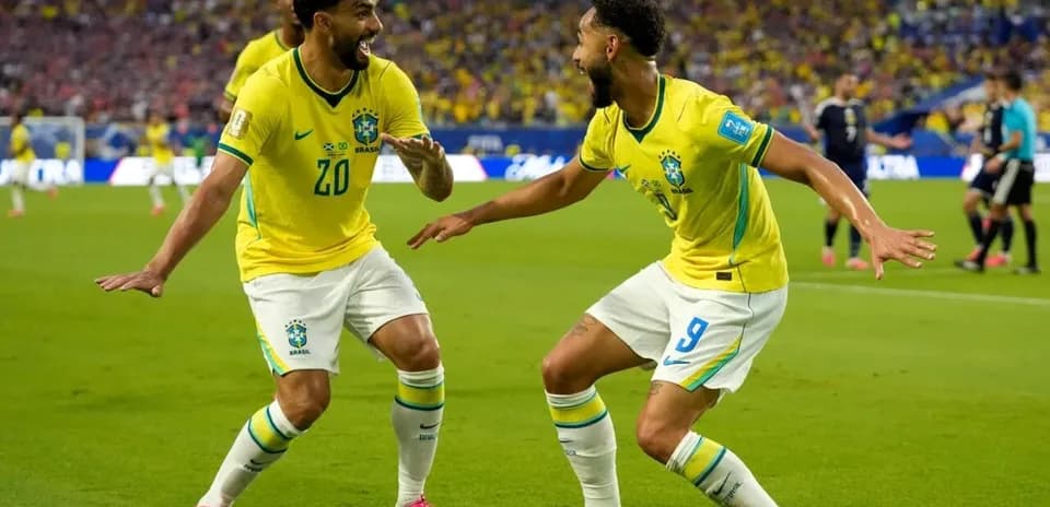 Two Brazil players celebrating a goal on the field