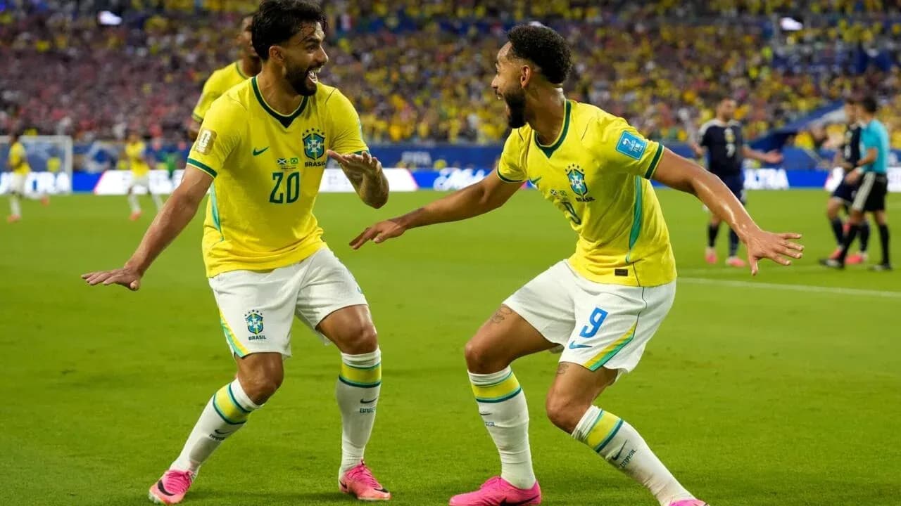 Two Brazil players celebrating a goal on the field