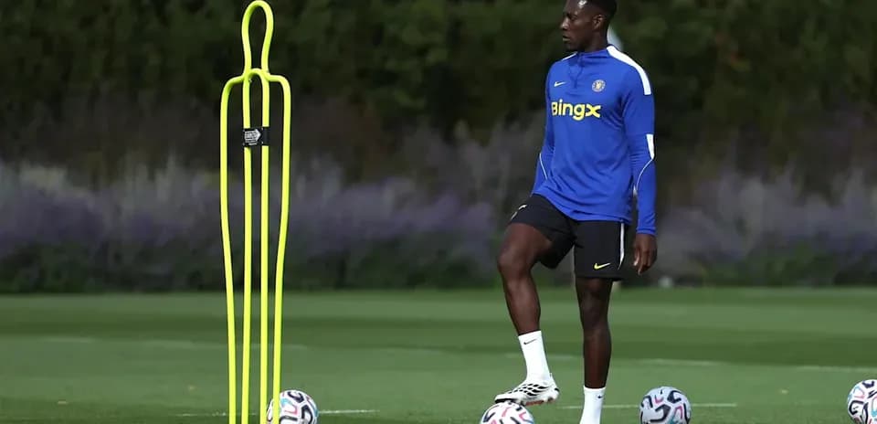 Player practicing near training dummy and soccer balls