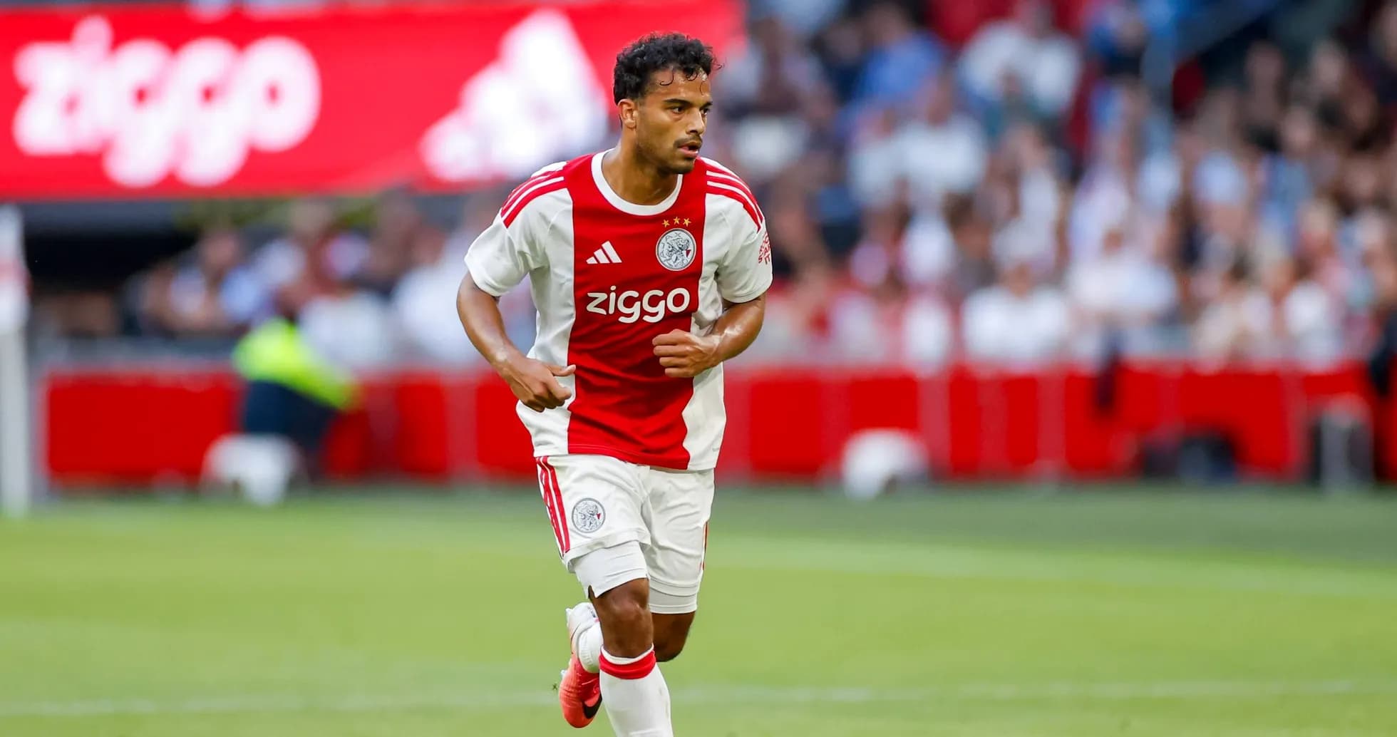 Player in Ajax kit running with the ball