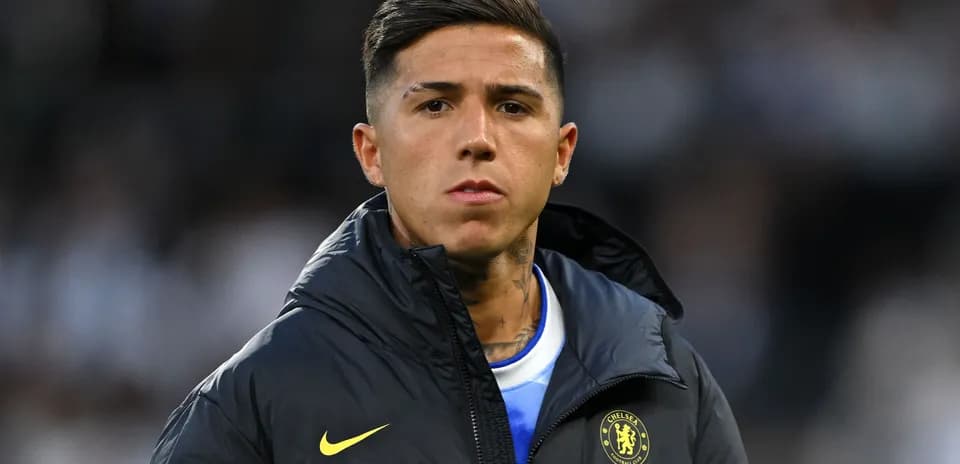 Player in Chelsea jacket during match warm-up