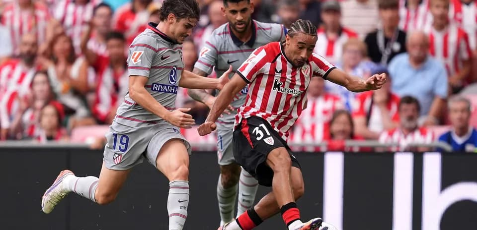 Athletic Club player dribbling past Atletico Madrid defenders