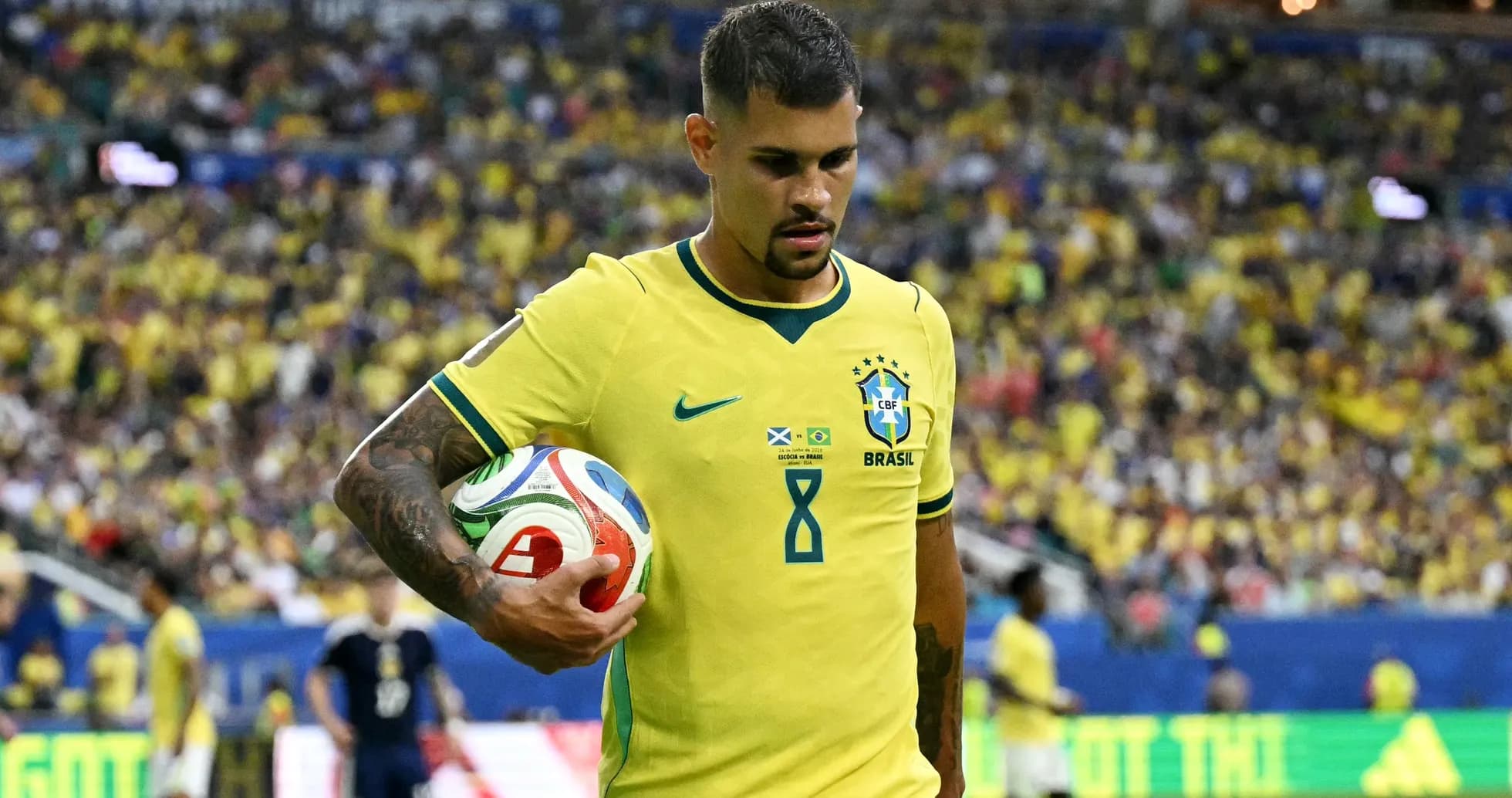 Player in yellow jersey holding a soccer ball