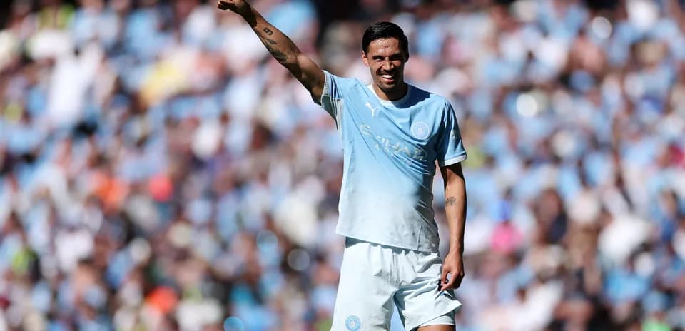 Player gesturing to crowd during match at stadium