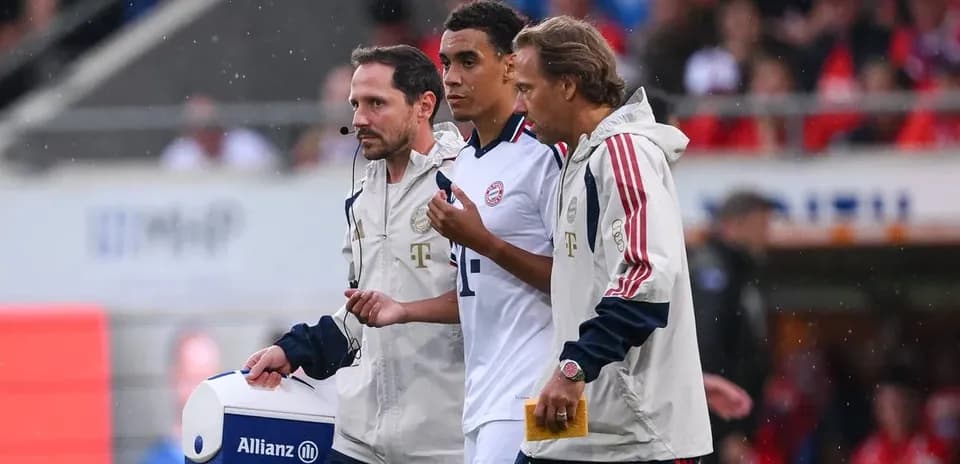 Medical staff assisting player off the field