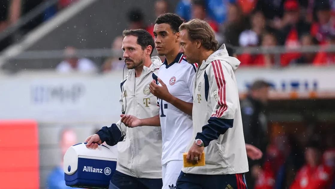 Medical staff assisting player off the field