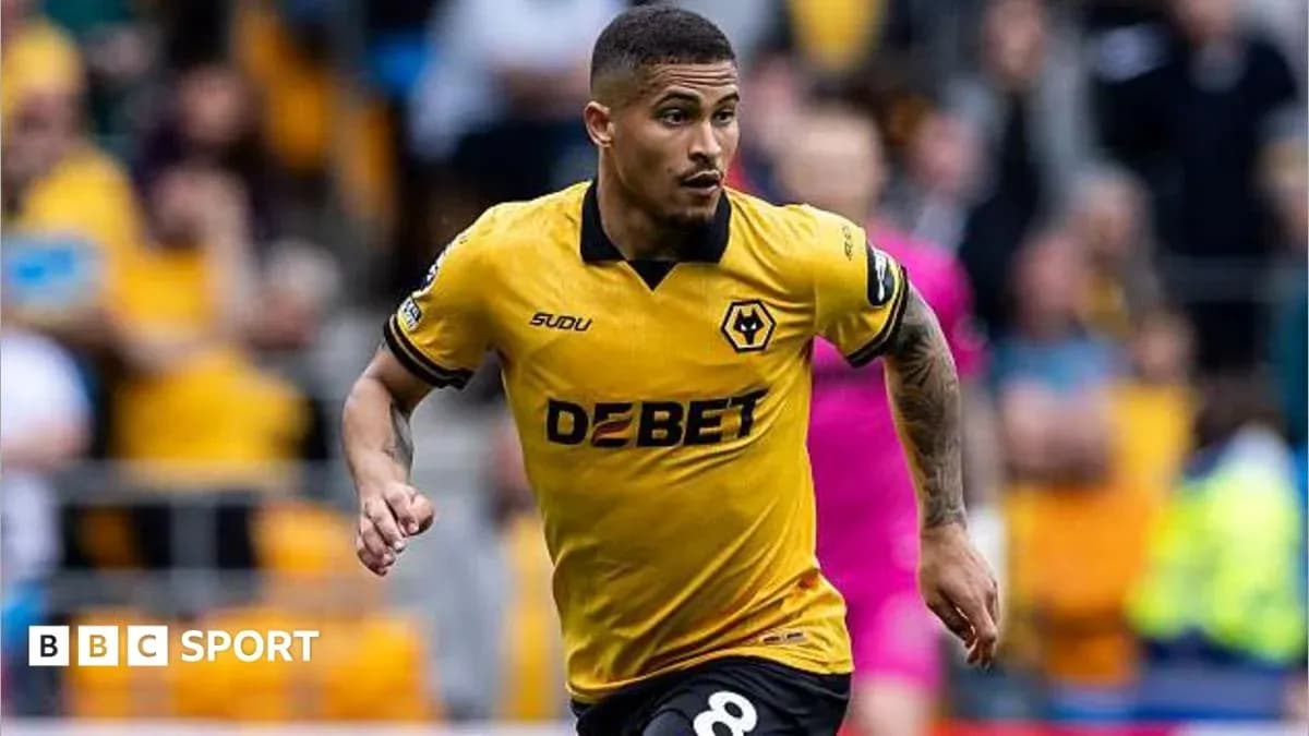 Player in yellow Wolves kit running on field